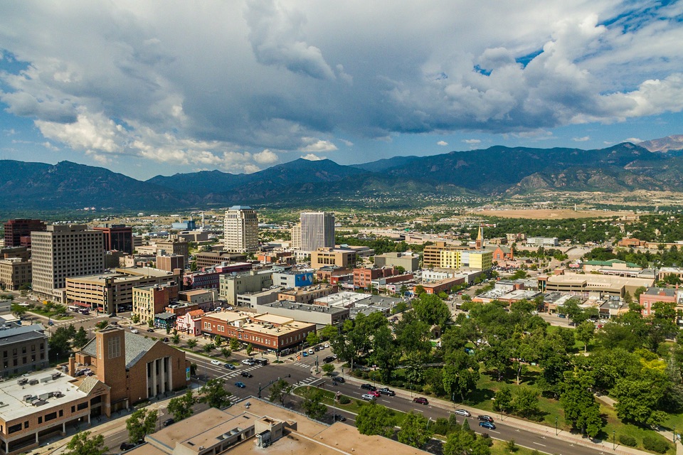 Downtown Colorado Springs from above, looking over Acacia Park toward Pikes Peak