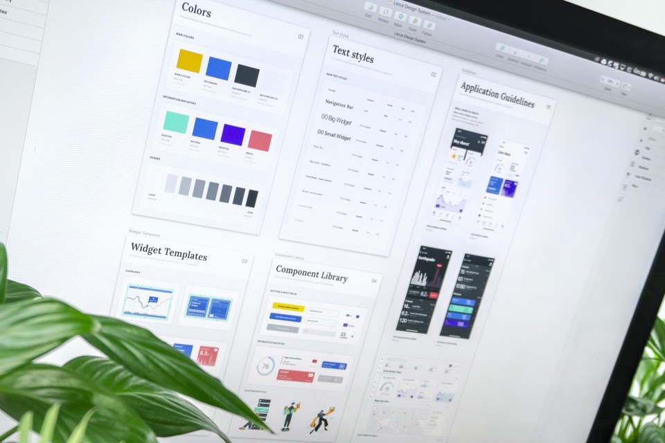 A monitor showing a design system: colors, text styles and a component library